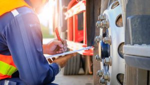 Employee checking the measurement of a truck tire