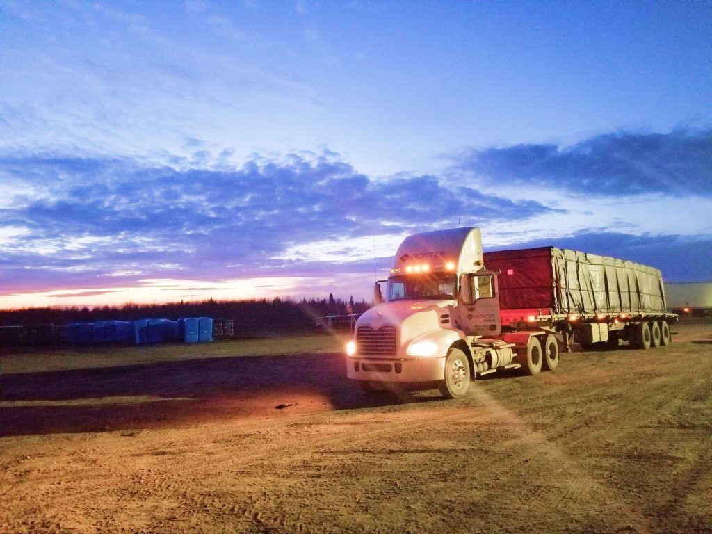 Truck driving through sunrise