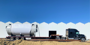 Truck with white fence and blue skies in the background